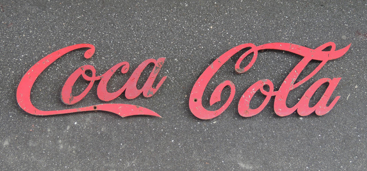 This sign originally hung on a Coca Cola Bottling Company building in Longview, Texas. It was made in the first half of the 20th century, circa 1910. This sign contains seven different parts.