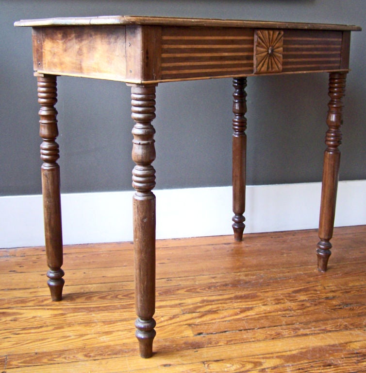 A Jamaican mahogany huntboard or serving table with turned legs, inlaid front and a sunbrurst motif center medallion. British Colonial