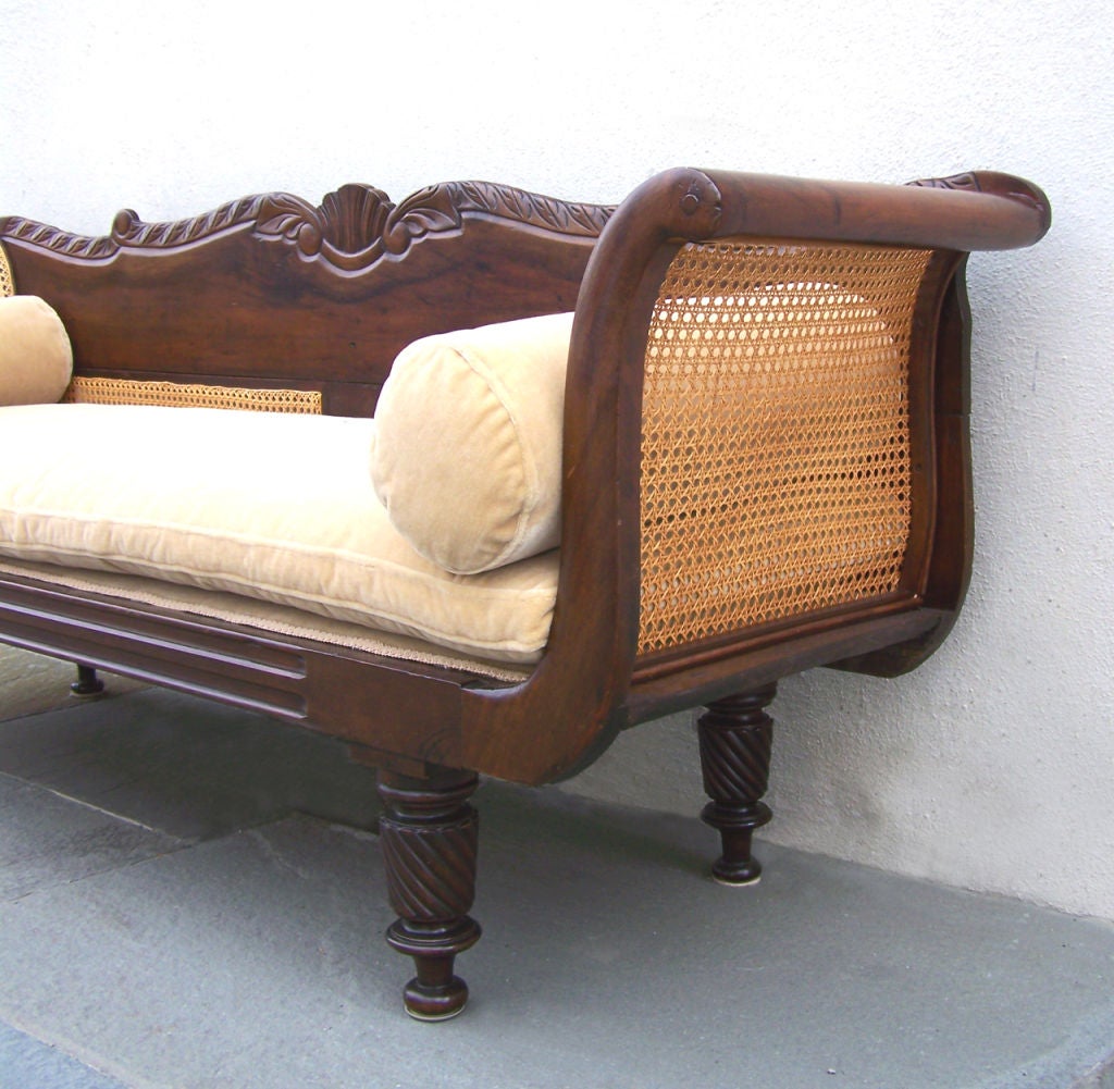 A wonderful carved mahogany, cane and upholstered sofa.