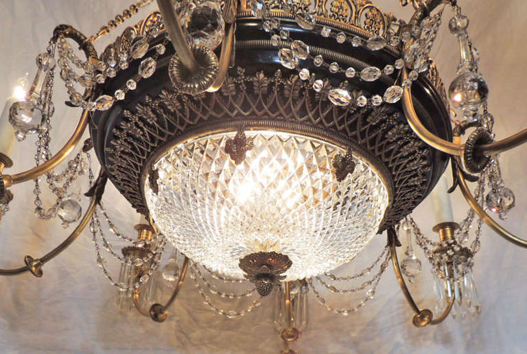 This chandelier was made in France in the late-19th century and was created in a Russian Empire style. The crystal bowl is diamond cut and has a central bronze finial on the bottom. The arms are also made of bronze and feature crystals hanging from