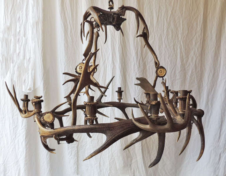 This horn chandelier was made in Scotland around year 1800 or 1810. This is an authentic deer antler piece, even the bobeshes are made of antler. This piece was made for use with candles and still features the original pulley system that was used to