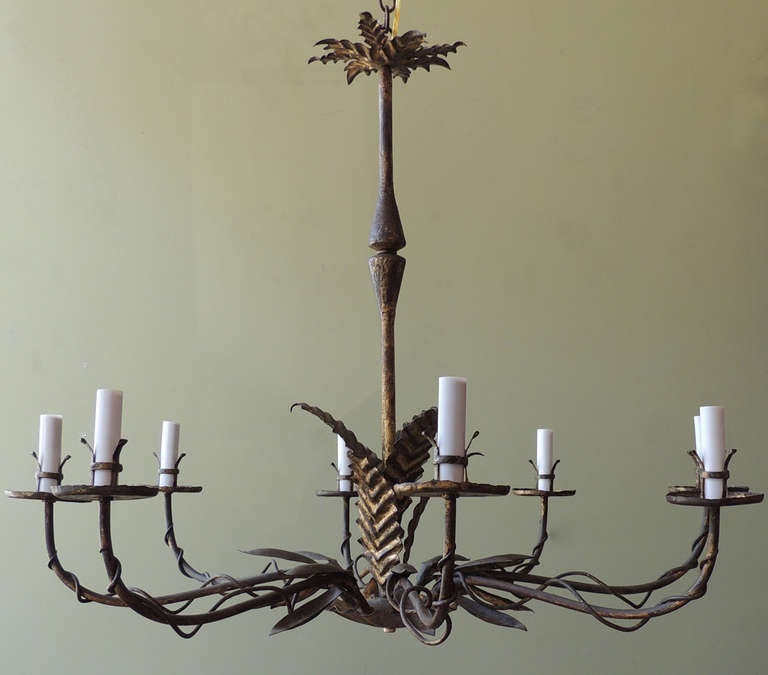 This eight-arm chandelier has natural details including arrangements of leaves and vines. This piece is a 1950s style chandelier made Barcelona, Spain.