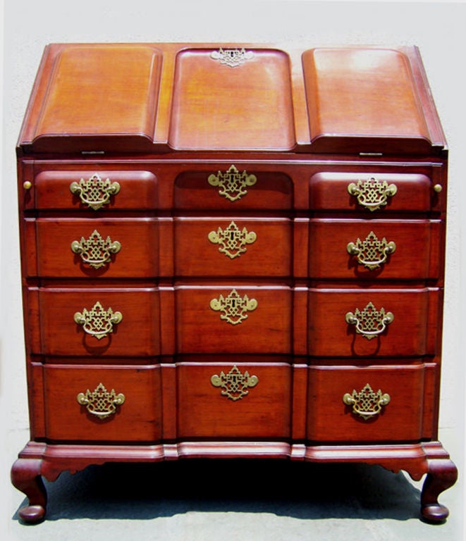 This secretary is a prime example of American craftsmanship. Four large drawers lie underneath a spacious writing space with many compartments for storage. Complete with unique and original brass pulls, this piece is sure to be a wonderful addition
