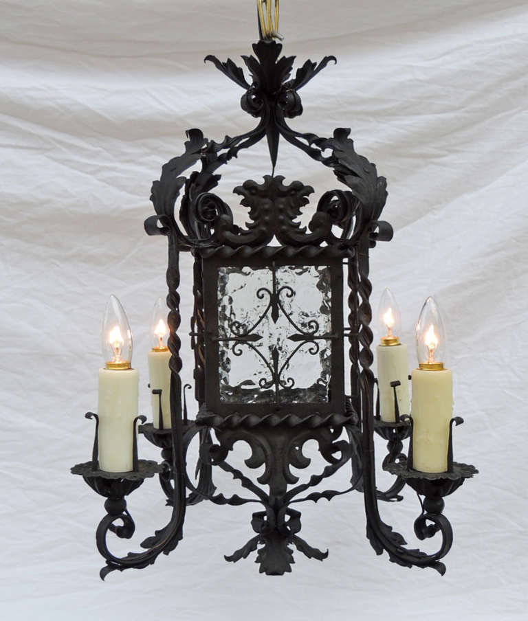 This Spanish lantern was made in the mid-19th Century, circa 1850. The middle section of this piece has four blown glass panels with a decorated central diamond. The bottom section has four arms decorated with foliage and scrolls. The top of this