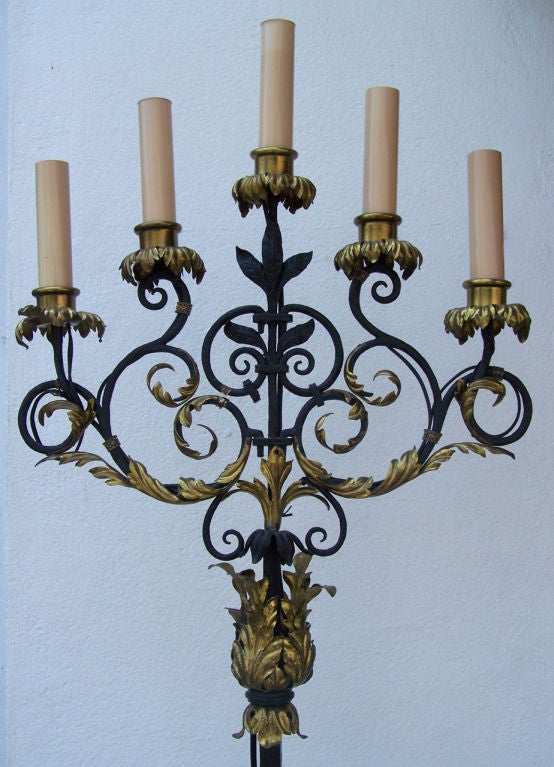 An tall pair of five-light hand-wrought iron and brass torchieres with decorative gilded foliate motifs. Originally candle.