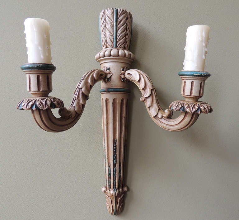 These sconces have two candle arms and are shaped like quivers. They are both French wired with porcelain sockets and use candelabra bulbs. The sconces are highlighted with a green paint.