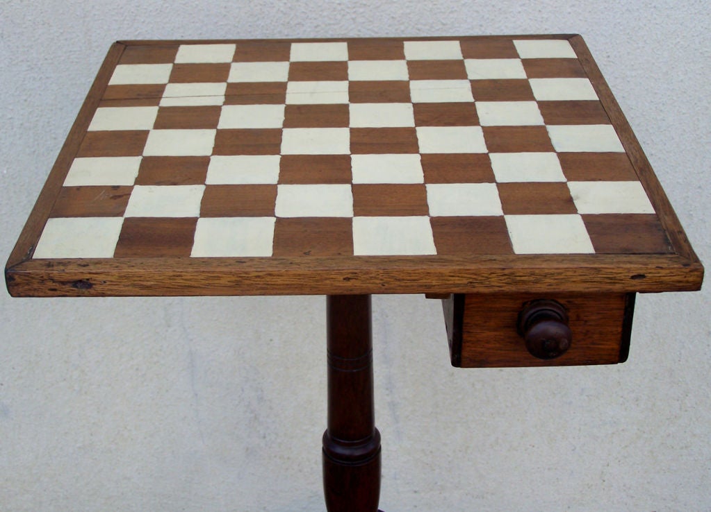 This unusual early 19th century Caribbean mahogany and cedrela chess game table from St. Croix, circa 1840, with Classic West Indies legs featuring spurred knees. The centre post of this British Colonial table is hand-turned and the game table has