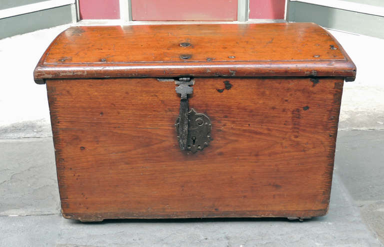 This Caribbean trunk was made in Cuba during the late-17th century. This Spanish Colonial piece is made of solid mahogany and features an iron lock. It has a slightly rounded top with flat sides.