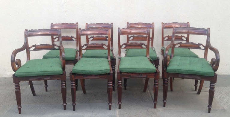 This beautiful set of eight chairs would be an excellent addition to any dining room. These chairs are made of tropical wood and feature carved ribbed detail located on the stile and of the two arms of the chairs.