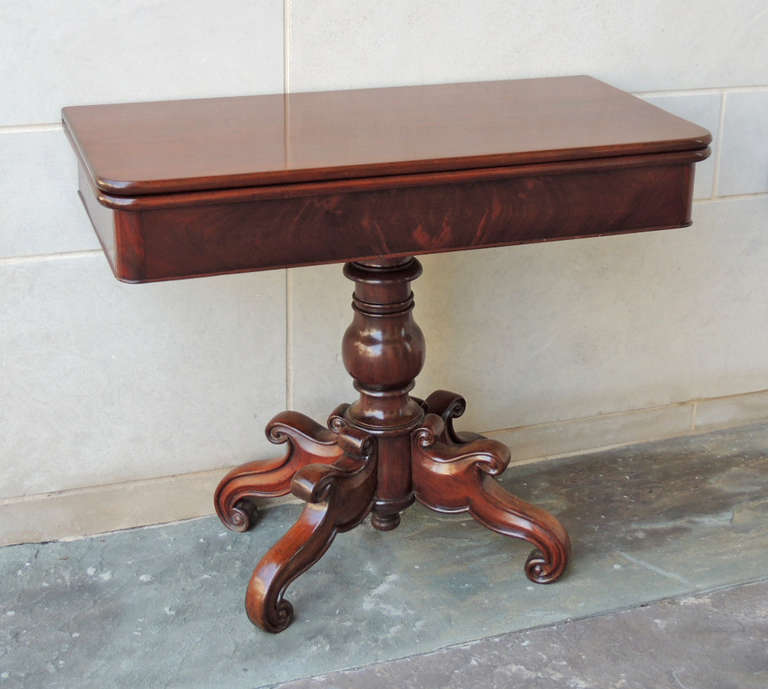This card table was made on the island of St. Croix in the 19th Century, circa 1830. This piece is primarily made of mahogany with cidrella as a secondary wood. The top of this table opens and slides to the side, revealing a secret pocket. When the