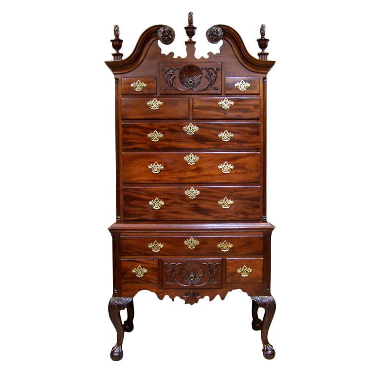 Philadelphia Highboy with carved shell and foliate top drawer over five drawers and a carved shell and foliate bottom drawer with three he description noted that it was in two parts, had a pierced foliate-carved cartouche and flame finials, and had