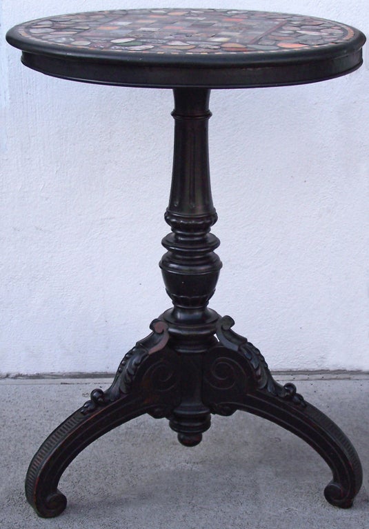 A very unique marble top specimen chess table. This table features  a wide and colorful variety of polished marble. The three leg stand is also beautifully carved with acanthus leaves and scroll work