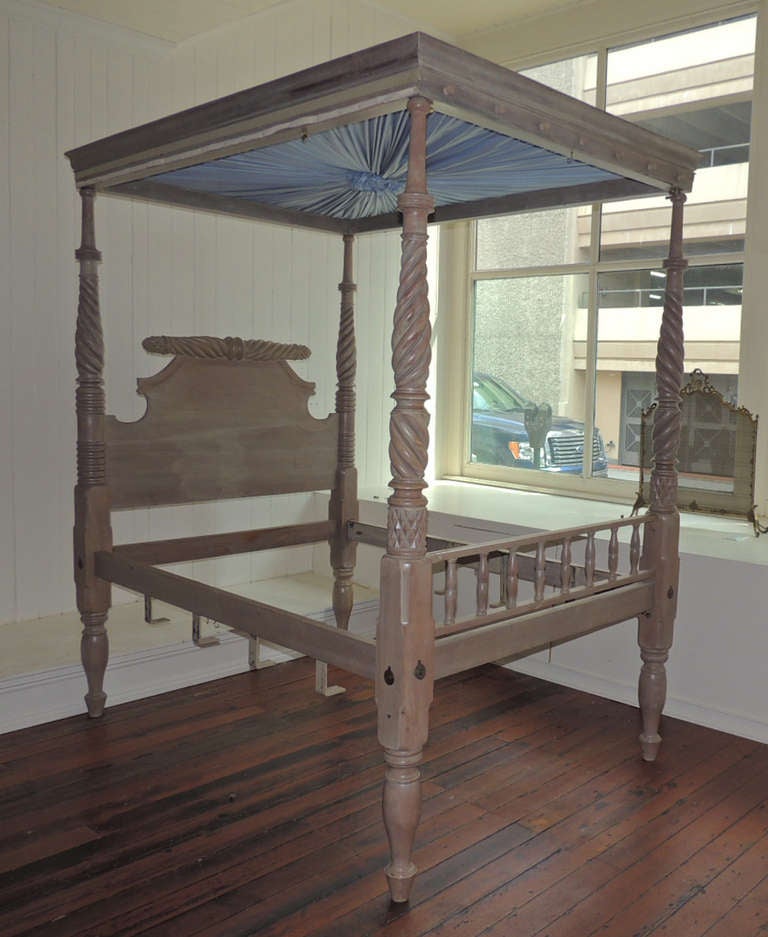 This wonderful bed is made of solid mahogany with a light blonde finish and hand turned detail on all the rails. It was constructed in The US Virigin Island of St. Croix in the 1820's to 1830's. The vertical rails feature opposite turned detail