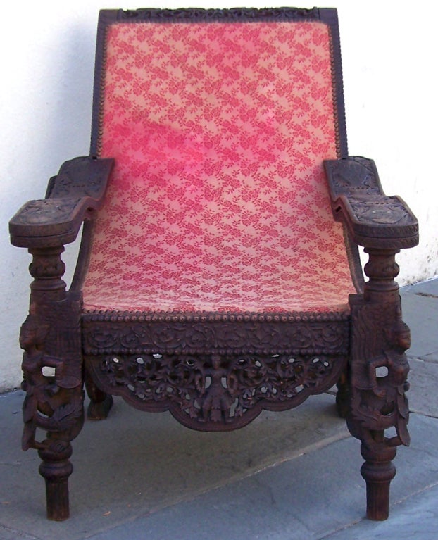 This late-19th century Anglo-Indian campeche chair is truly unique. The piece features elaborate carvings all-over, including winged and mermaid-like figures, peacocks, and fish carved into the arms. 
