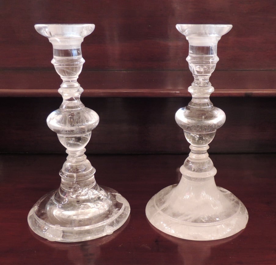 This pair of rock crystal candlesticks was made in France in the first half of the 20th Century. Their simple style lets the beauty of the natural rock crystal shine through.