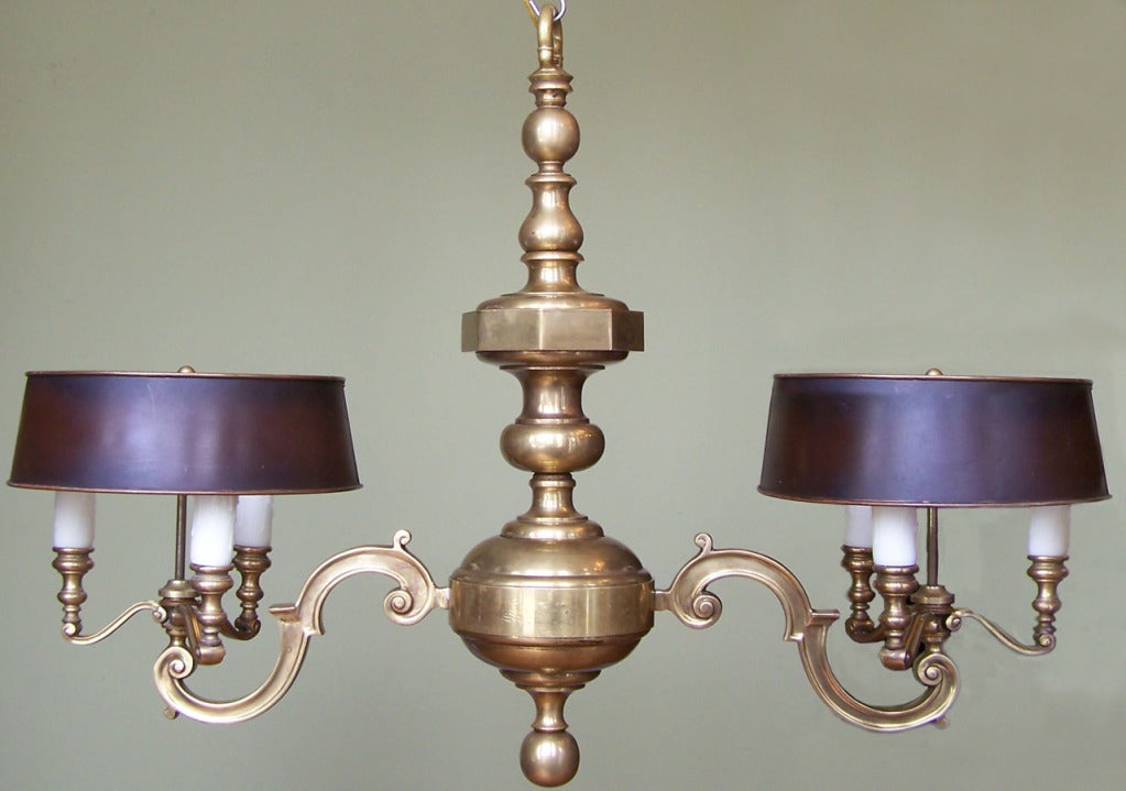 A truly beautiful French 1850s chandelier with two large arms that each hold three lights. Two black tole shades complement this brass chandelier.