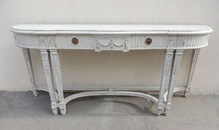 This beautiful table is made of mahogany and painted a white grey color. The front legs are decorated with sunburst and scrolls designs. This piece has one drawer that is almost the length of the entire table.