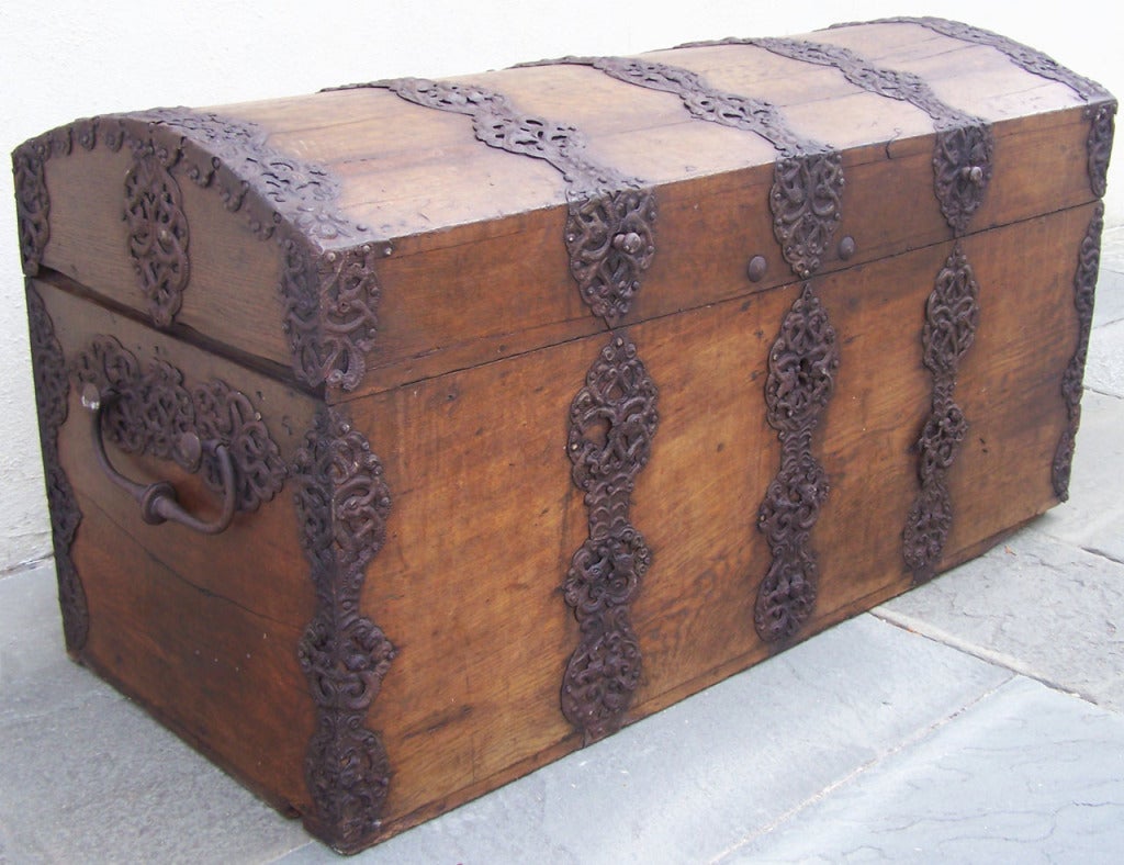 A wonderful oak Spanish chest with decorative iron elements throughout.