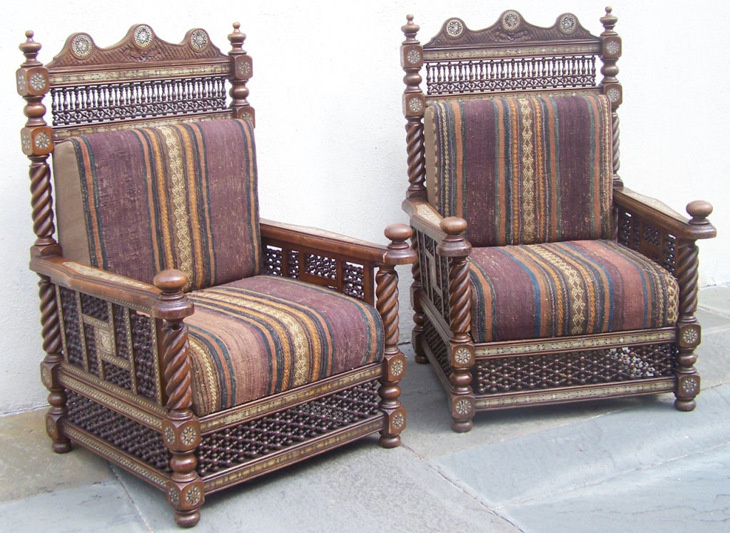 A truly wonderful pair of Syrian chairs (one of two pairs). Hand carved mahogany with stunning mother of pearl and bone patterned inlay. Recently reupholstered.