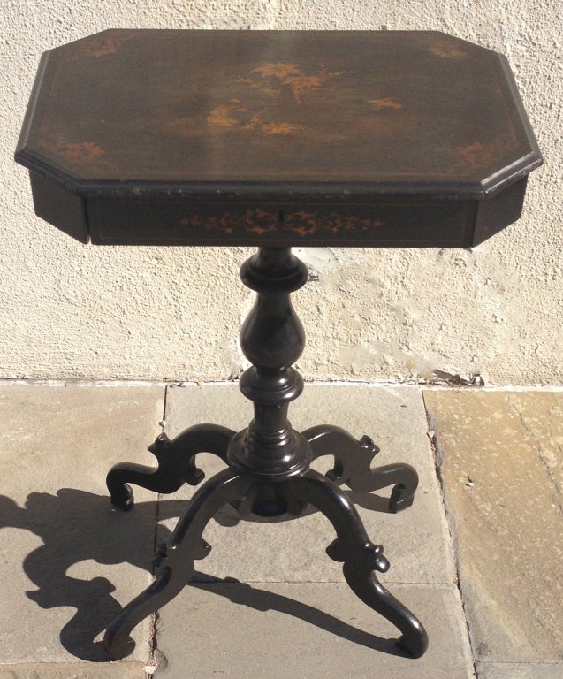 A beautiful English Regency ladies work table. This piece features scrolled feet, turned center post, and a hand painted table top in a beautiful chinoiserie style. This piece also features a drawer with multiple compartments.