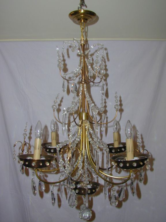 Double Tiered Crystal Fountain Corona Resting on Antique Brass Pierced Dome with Faceted Crystals over Four Arms Inside Pierced and Crystal Faceted Cups Interspersed  with French Pendalogues over another Pierced Dome with Faceted Crystals