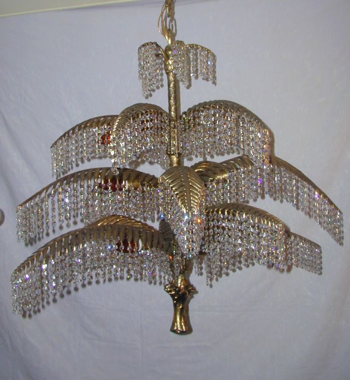 Rare Art Deco Bronze Chandelier Featuring Multiple Branches of a Palm Tree Laden with Crystal Foilage Culminating in a Sculpted Palm Tree Trunk.  Originally in an 1930's Art Deco Hotel in Cincinnati, Ohio.  Fully restored.
