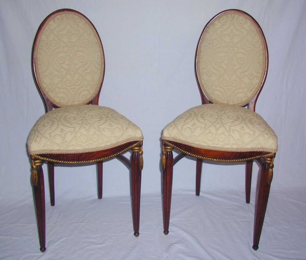 Fantastic Pair of French Art Deco Side Chairs having Upholstered Oval Backs and Seats with Carved and Gilded Rope Twist and Tassel Decoration Supported on Turned and Reeded Legs.