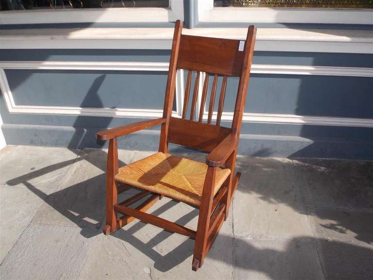 American Walnut rocking chair with rush seat. 19th Century