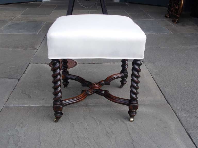 English mahogany barley twist foot stool with carved molded edge stretchers, centered decorative medallion, and terminating on original brass casters.  Stool is covered in white muslin with original horse hair.   Early 19th Century