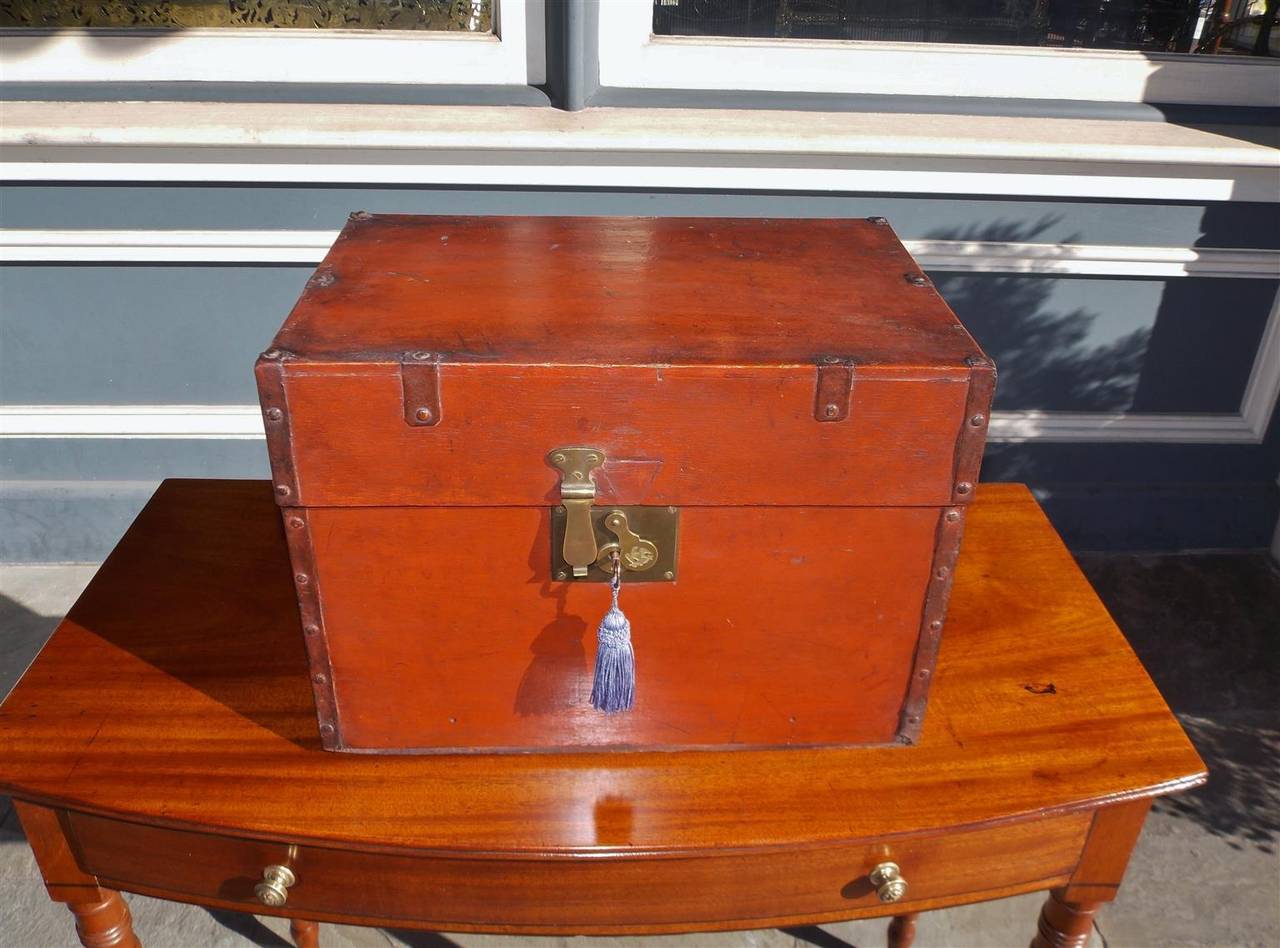 American pine liquor traveling case with fitted interior consisting of original stenciled gilt glasses and bottles with stoppers, iron carrying side handles and original brass locking mechanism with key, Early 19th century.