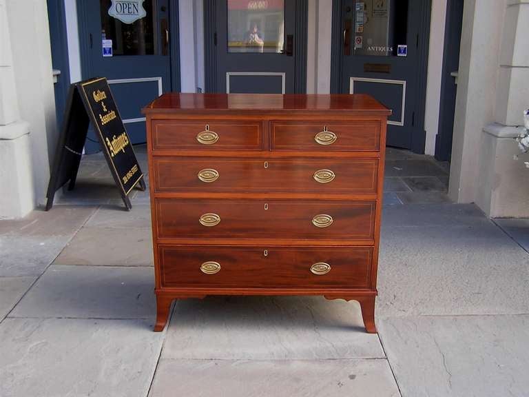American mahogany Hepplewhite graduated five drawer chest of drawers with Satinwood string inlay, oval brass pulls, and terminating on original splayed feet.  18th Century