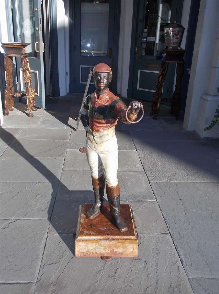 American painted standing cast iron jockey on squared plinth. Mid 19th Century