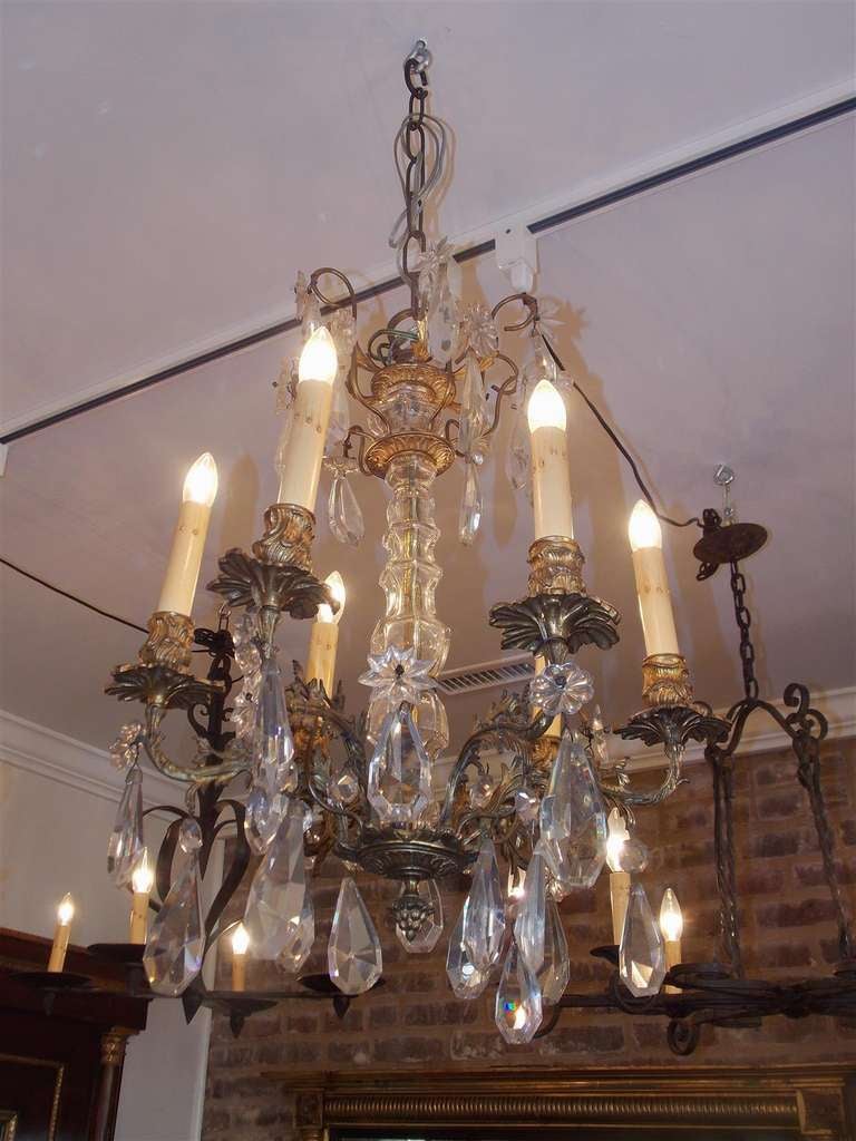 French gilt bronze and crystal six light chandelier with centered crystal column and floral motif.  Early 19th Century