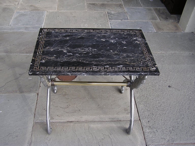 French polished steel and brass marble top garden table supported by swan decorative legs with carved Greek key inlay, Dealers please call for trade price.