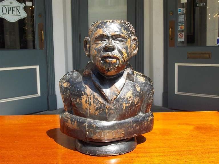 American carved wooden bust of Jamaican, Marcus Garvey on circular plinth.  Signed brass plaque Marcus. Early 20th Century

Marcus Mosiah Garvey, Jr., ONH (17 August 1887 – 10 June 1940),[1] was a Jamaican political leader, publisher, journalist,