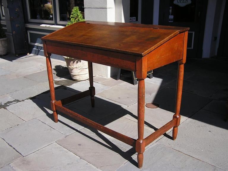 American poplar slant front cotton factor desk with hinged flip top, leading to an open interior,  and terminating on turned bulbous legs with stretchers. All original.  Dealers please call for trade price. 
