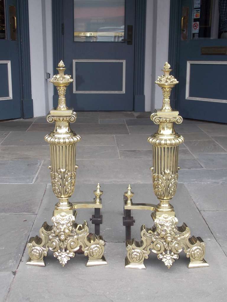 Pair of monumental American brass floral andirons with lions head motif and original log stops.  Signed Jackson, New York  Circa 1906
