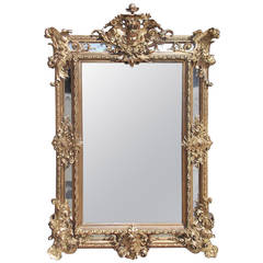 French Gold Gilt and Floral Carved Cherub Beveled Mirror. Circa 1820