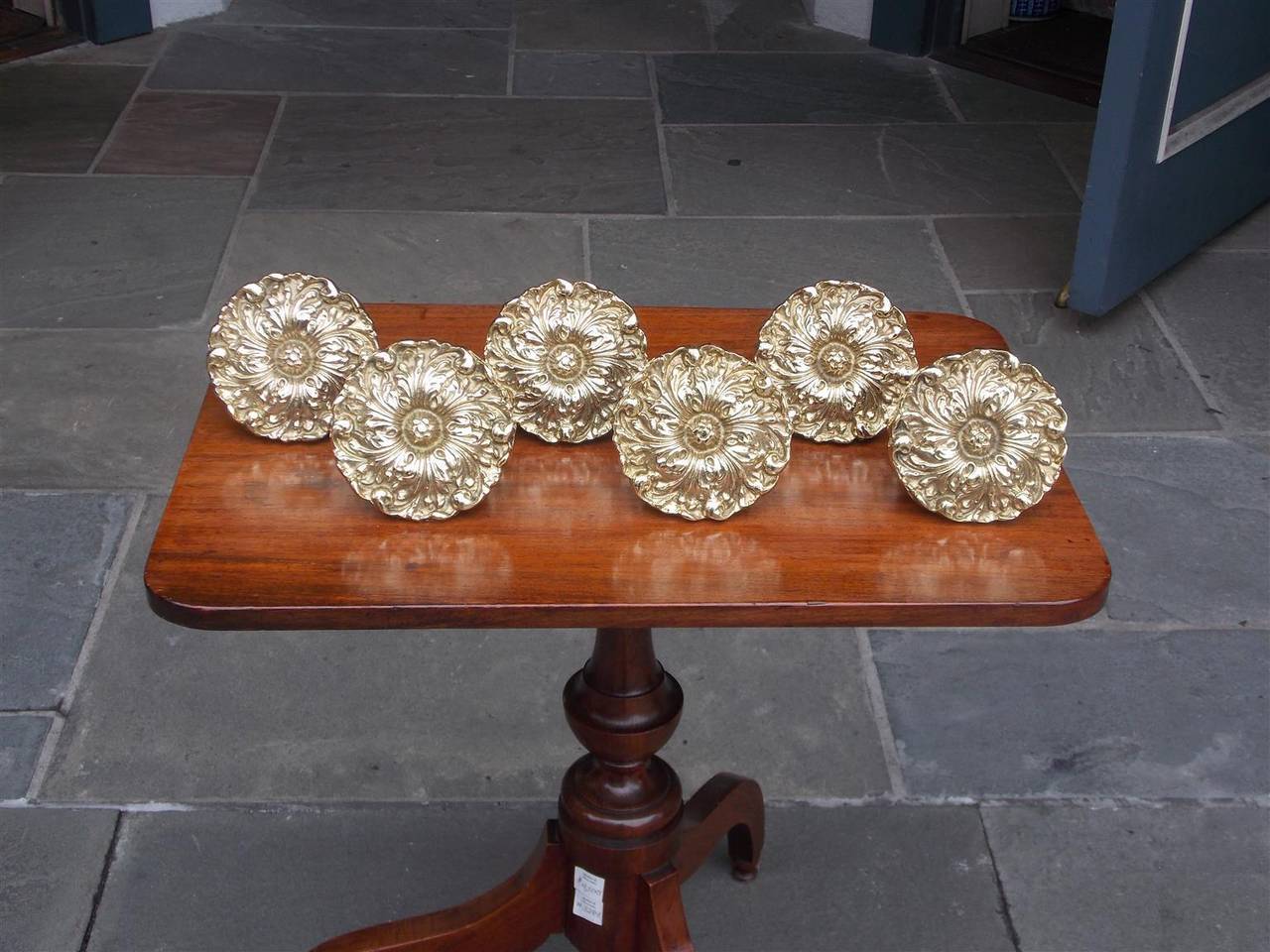 Set of four American cast brass tie backs with mounting screw and floral motif. Stamped Harvin, Baltimore.  Late 19th / Early 20th Century.