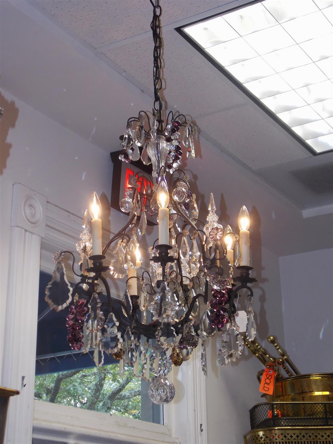 French bronze and crystal six-light chandelier with amethyst grape clusters, crystal spheres, and terminating with a cut crystal ball. Chandelier was originally candle powered and has been electrified, Early 19th century.