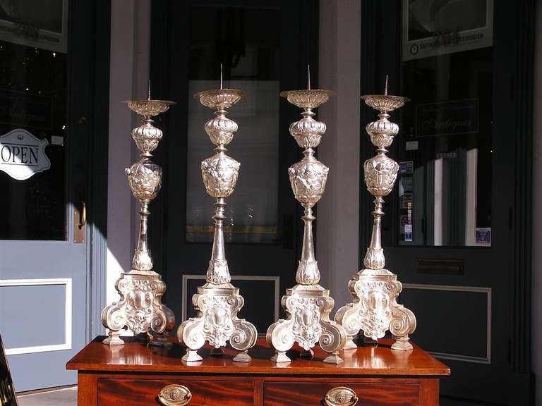 Set of four Italian silver gilt over tin prickets with floral motif and scrolled legs. Candle powered.  Dealers please call for trade price. 