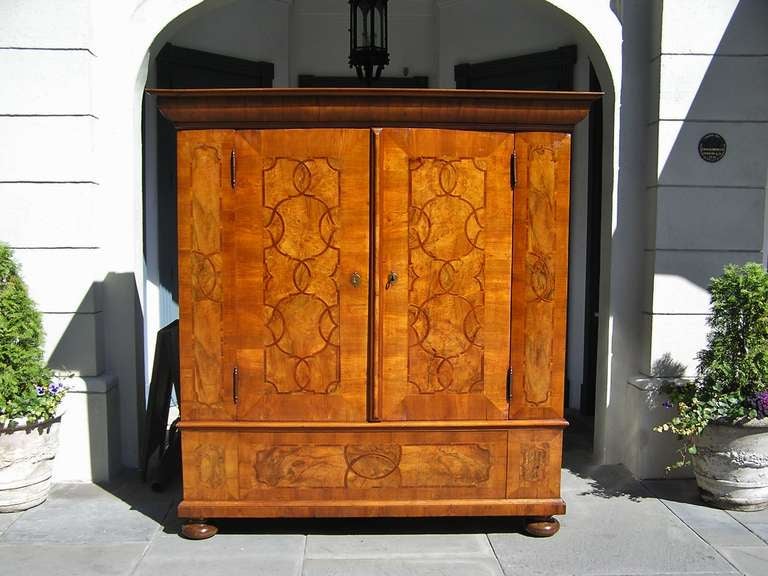 Austrian Biedermeier Burl Walnut & Mahogany cask with carved molded edge cornice, flanking book matched hinged doors, tulip wood inlays, satinwood inlays, original steel engraved locks & hinges , secret hinged till,  and terminating on a carved