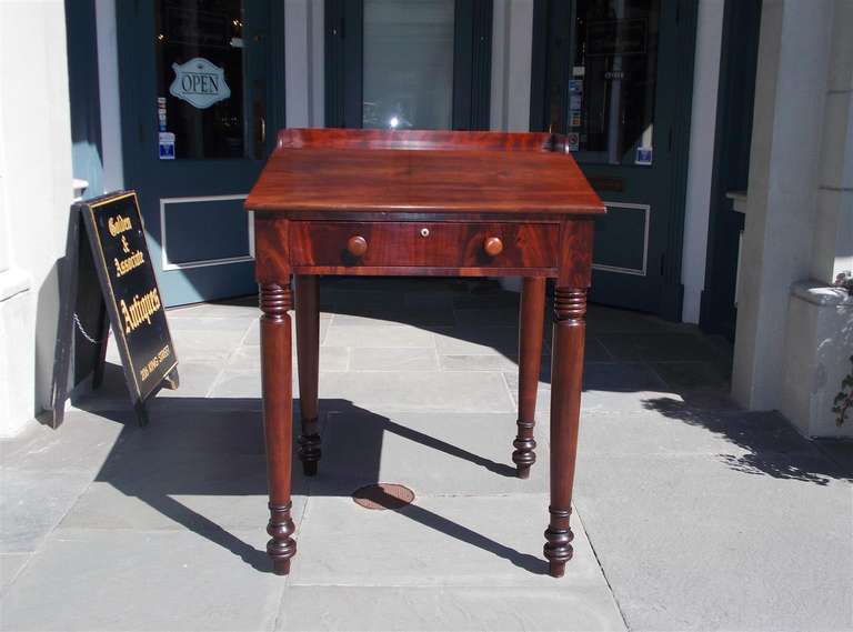 American Sheraton slant top mahogany one drawer plantation desk with original wooden knobs and terminating on bulbous ring turned legs. Early 19th Century