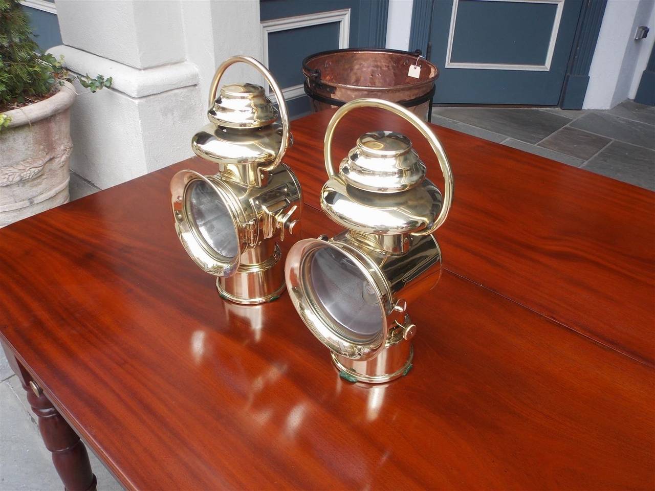 Pair of American brass carriage lanterns with dome globe, side mount, carrying handle, and original font. Pair can be electrified if desired, Early 20th Century.
