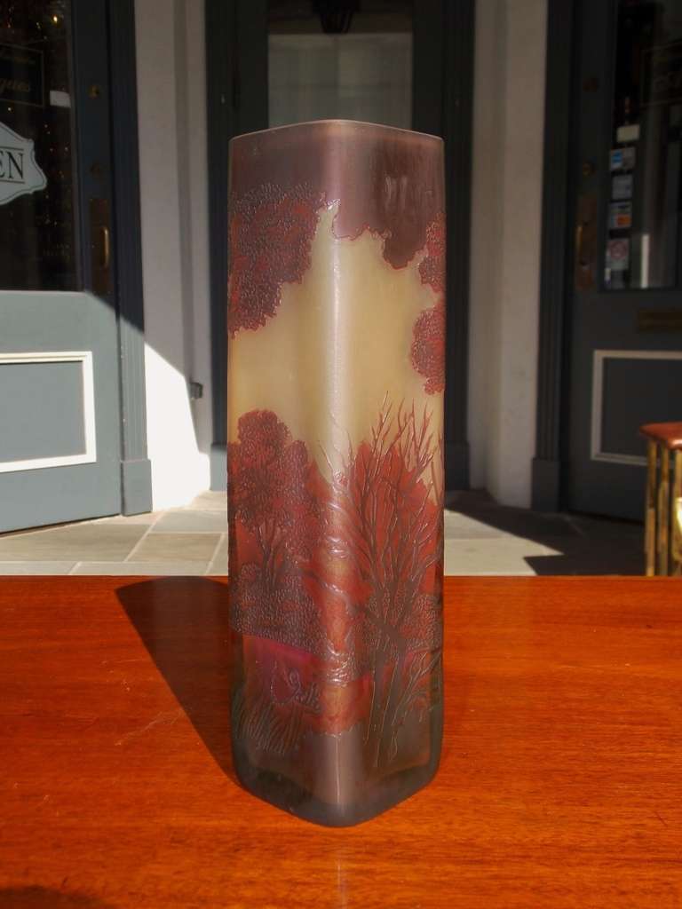 A superb late 19th Century French cameo glass vase of tall squared form. The vase has a stunning deep red and burgundy acid cut etched floral landscape against a rich yellow field. This vase exhibits extremely fine color and finish, Signed Gallé 