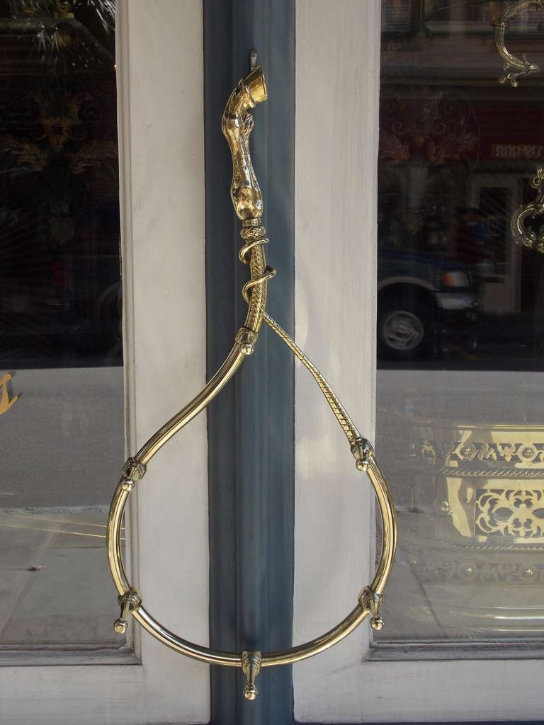 English brass six peg hanging riding crop holder with intertwined braided crop connecting to horse leg and hoof motif. Dealers please call for trade price. 