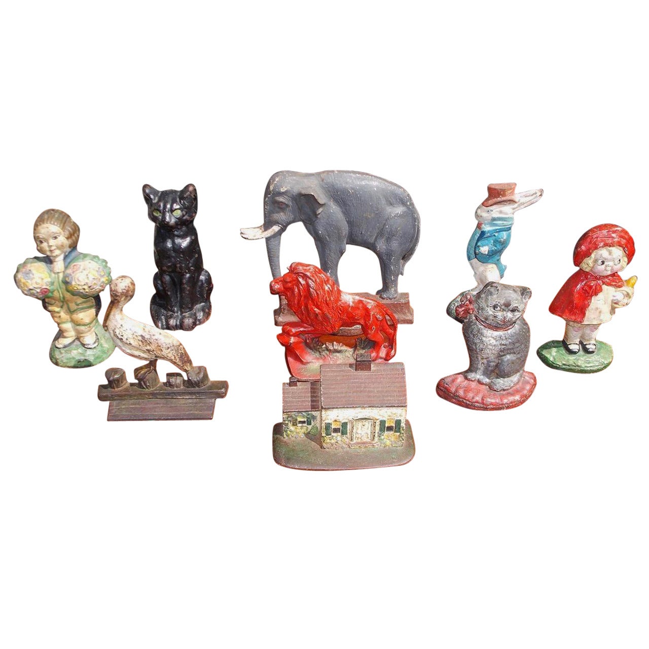 Set of cast iron vibrantly painted decorative doorstops, Early 20th century.
Set consist of elephant, rabbit, lion, two cats, two young ladies and country cottage. Select doorstops are signed by maker. Many more options to select from in our