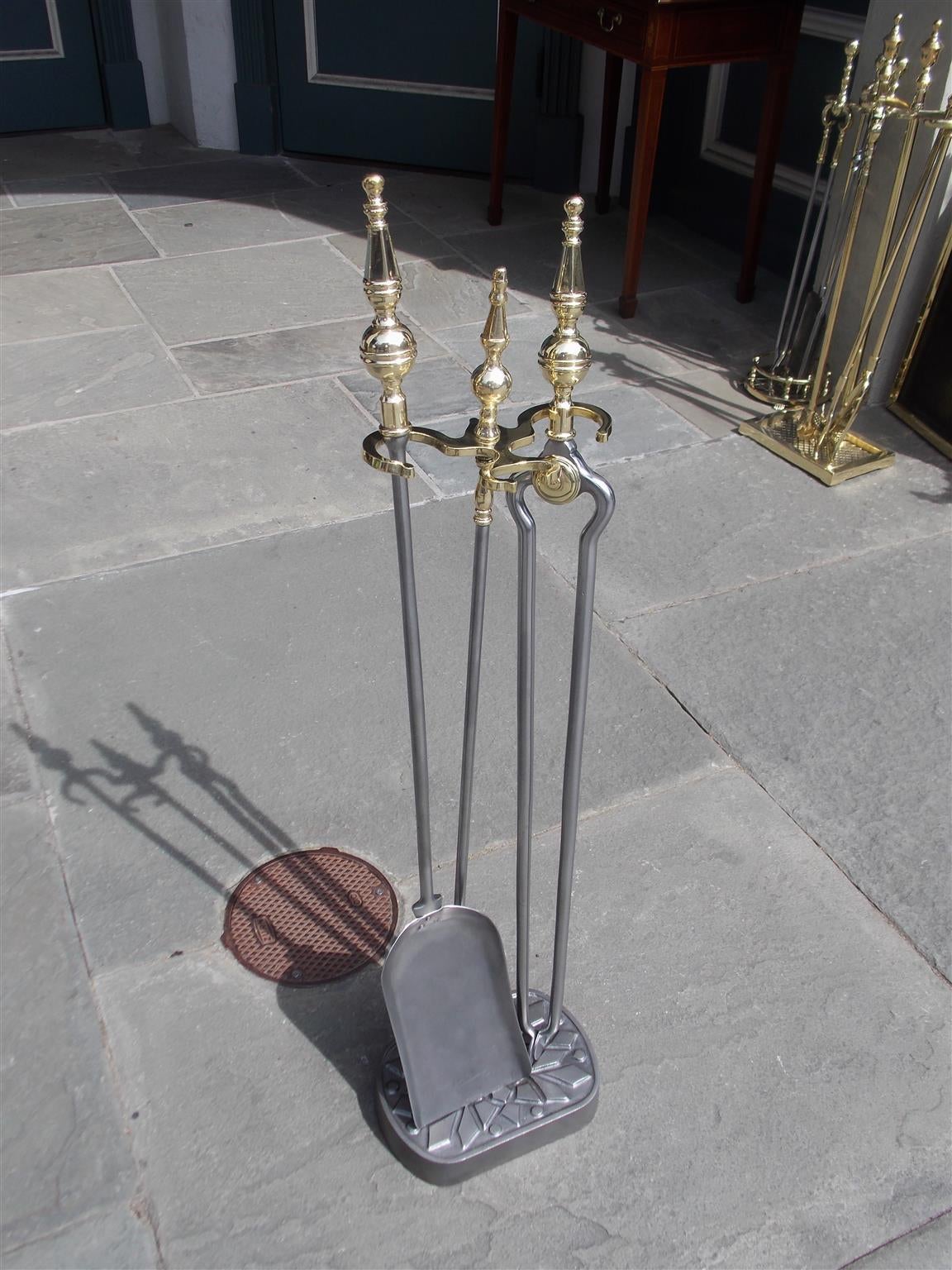 Ensemble d'outils à feu en laiton américain et en acier poli Steele top sur un support décoratif à facettes.  L'ensemble se compose d'une pince et d'une pelle.  New York, milieu du 19e siècle