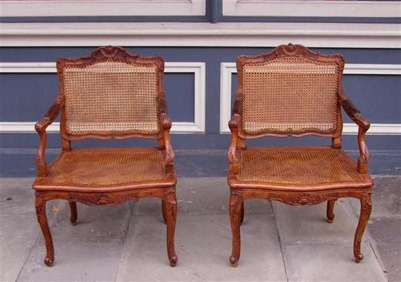 Pair of French Walnut Foliage and Shell Arm Chairs with Cane Seats C. 1820  In Excellent Condition For Sale In Hollywood, SC