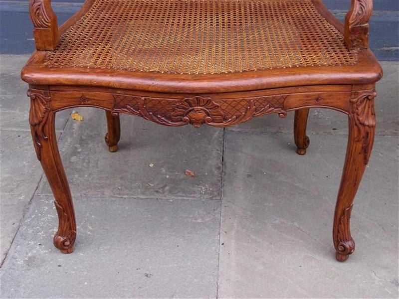 Upholstery Pair of French Walnut Foliage and Shell Arm Chairs with Cane Seats C. 1820  For Sale